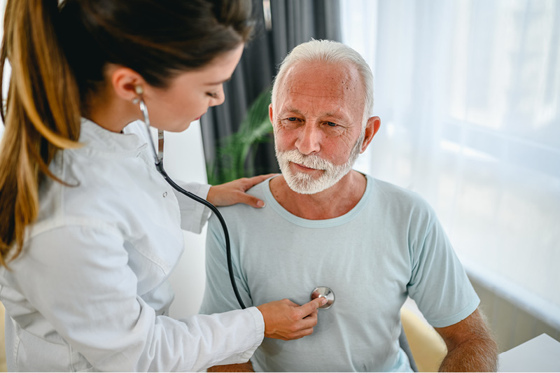 Doctor listening to a man's lungs